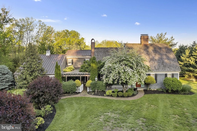 1249 Pebble Hill Rd, Doylestown, PA 18901 - back of property featuring a chimney, a standing seam roof, a lawn, and metal roof