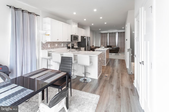 644 Lakemont Dr, Glen Burnie, MD 21060 - kitchen with appliances with stainless steel finishes, open shelves, white cabinets, a peninsula, and light countertops