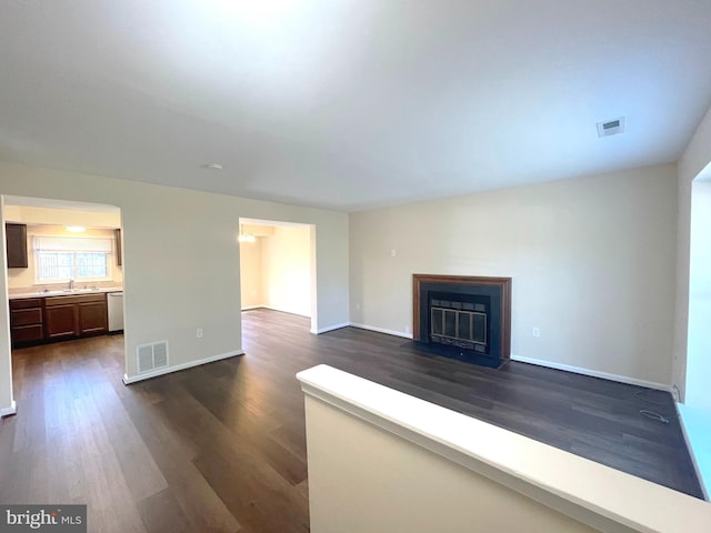 4522 Grouse Pl, Waldorf, MD 20603 - unfurnished living room with a sink, dark wood-style floors, baseboards, and a fireplace with flush hearth
