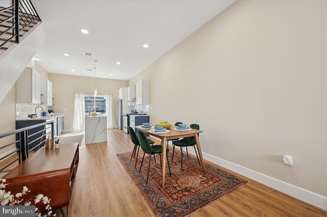 6210 Clearview St, Philadelphia, PA 19138 - dining area featuring light wood-type flooring, baseboards, recessed lighting, and stairs