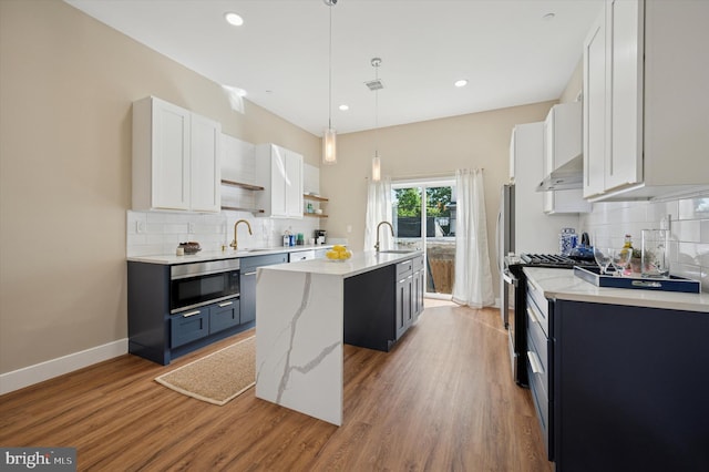 6210 Clearview St, Philadelphia, PA 19138 - kitchen with a kitchen island with sink, stainless steel gas range, tasteful backsplash, wall oven, and recessed lighting