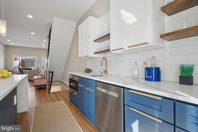 6210 Clearview St, Philadelphia, PA 19138 - kitchen featuring open shelves, blue cabinetry, stainless steel appliances, a sink, and light wood-style flooring