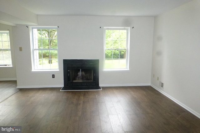 302 Independence Dr, Southampton, PA 18966 - unfurnished living room featuring dark wood-style flooring, a fireplace with raised hearth, and baseboards