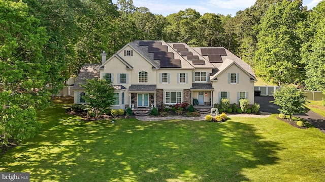 2 Jessica Ct, Tabernacle, NJ 08088 - view of front of property featuring stucco siding, roof mounted solar panels, roof with shingles, and a chimney