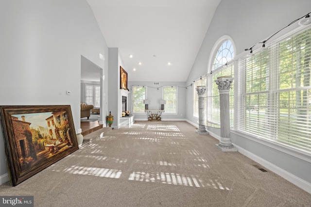 2 Jessica Ct, Tabernacle, NJ 08088 - unfurnished living room featuring high vaulted ceiling, carpet flooring, baseboards, healthy amount of natural light, and a lit fireplace
