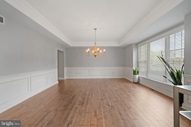 2 Jessica Ct, Tabernacle, NJ 08088 - unfurnished dining area with a chandelier, a raised ceiling, light wood finished floors, wainscoting, and crown molding
