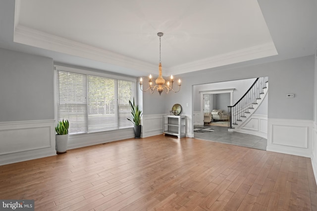2 Jessica Ct, Tabernacle, NJ 08088 - dining room with a chandelier, a tray ceiling, wood finished floors, stairs, and wainscoting