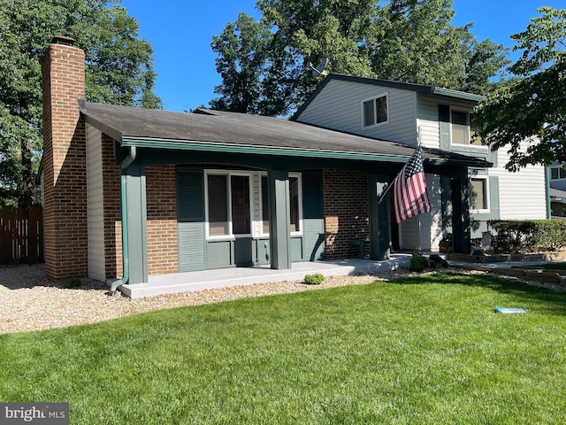 515 Sugarland Run Dr, Sterling, VA 20164 - view of front of property with brick siding, a front lawn, a chimney, and covered porch
