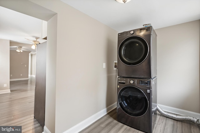 2808 Orleans St, Baltimore, MD 21224 - laundry room featuring stacked washer and clothes dryer, a ceiling fan, wood finished floors, and baseboards