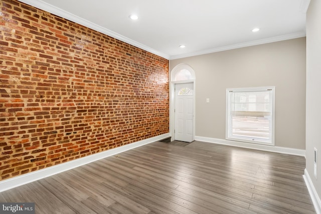 2808 Orleans St, Baltimore, MD 21224 - unfurnished room featuring baseboards, ornamental molding, brick wall, dark wood finished floors, and recessed lighting