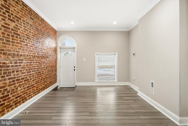 2808 Orleans St, Baltimore, MD 21224 - entryway featuring brick wall, crown molding, baseboards, wood finished floors, and recessed lighting