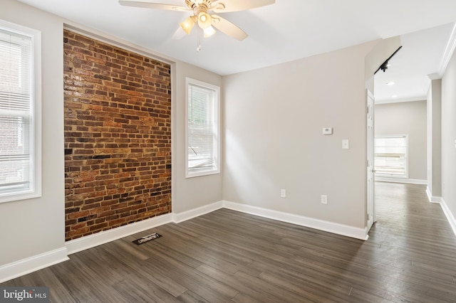 2808 Orleans St, Baltimore, MD 21224 - unfurnished room with a ceiling fan, dark wood-style flooring, baseboards, and brick wall