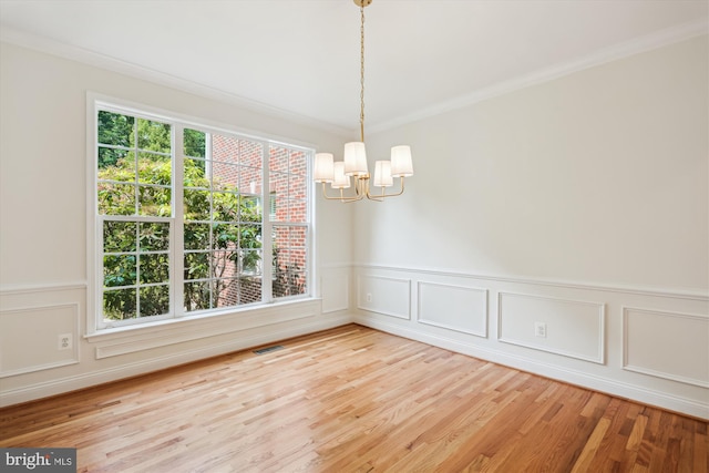 14908 Little Bennett Dr, Clarksburg, MD 20871 - spare room featuring a chandelier, crown molding, wood finished floors, a wainscoted wall, and a decorative wall