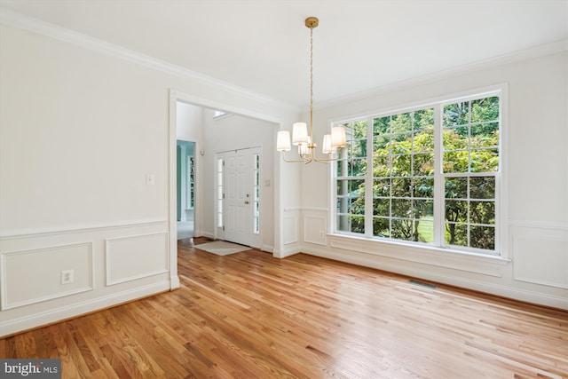 14908 Little Bennett Dr, Clarksburg, MD 20871 - unfurnished room featuring a chandelier, light wood-style flooring, ornamental molding, a decorative wall, and wainscoting