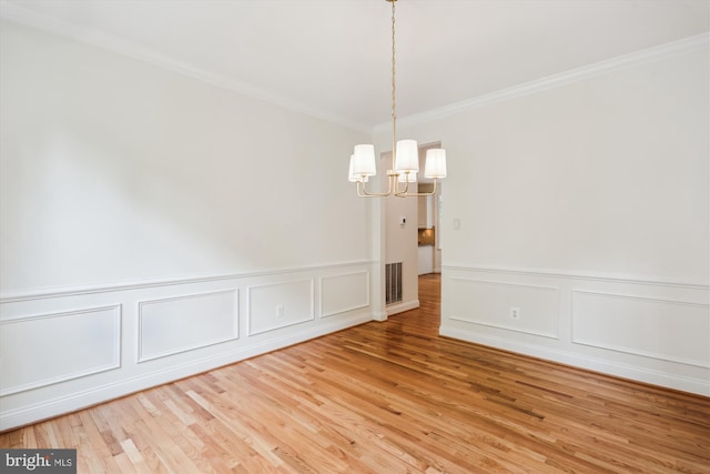14908 Little Bennett Dr, Clarksburg, MD 20871 - unfurnished room featuring a chandelier, ornamental molding, wood finished floors, a decorative wall, and wainscoting