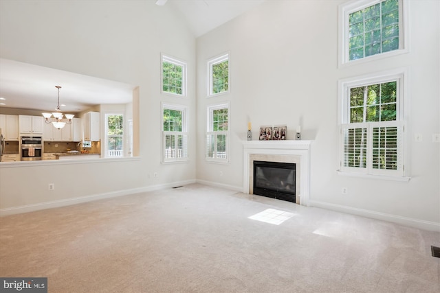 14908 Little Bennett Dr, Clarksburg, MD 20871 - unfurnished living room with high vaulted ceiling, a fireplace, a chandelier, and carpet floors