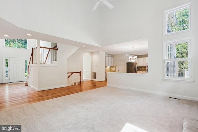 14908 Little Bennett Dr, Clarksburg, MD 20871 - unfurnished living room featuring a high ceiling, light carpet, healthy amount of natural light, recessed lighting, and baseboards