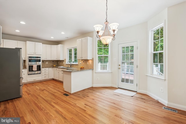 14908 Little Bennett Dr, Clarksburg, MD 20871 - kitchen featuring appliances with stainless steel finishes, a sink, light wood-style floors, a chandelier, and white cabinetry