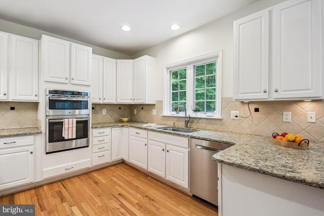14908 Little Bennett Dr, Clarksburg, MD 20871 - kitchen with a sink, appliances with stainless steel finishes, white cabinetry, light wood-style flooring, and recessed lighting