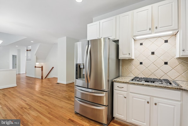 14908 Little Bennett Dr, Clarksburg, MD 20871 - kitchen with appliances with stainless steel finishes, tasteful backsplash, white cabinetry, light wood-style flooring, and light stone countertops