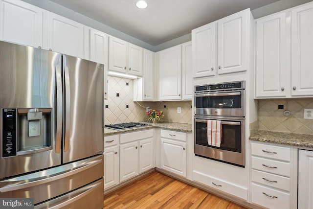 14908 Little Bennett Dr, Clarksburg, MD 20871 - kitchen with appliances with stainless steel finishes, backsplash, white cabinetry, light wood-type flooring, and recessed lighting