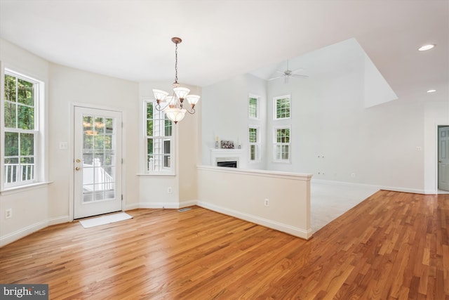 14908 Little Bennett Dr, Clarksburg, MD 20871 - unfurnished dining area with light wood-style floors, a chandelier, a fireplace, baseboards, and recessed lighting