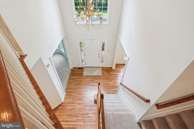 14908 Little Bennett Dr, Clarksburg, MD 20871 - foyer with stairs, light wood-style flooring, a towering ceiling, a chandelier, and baseboards