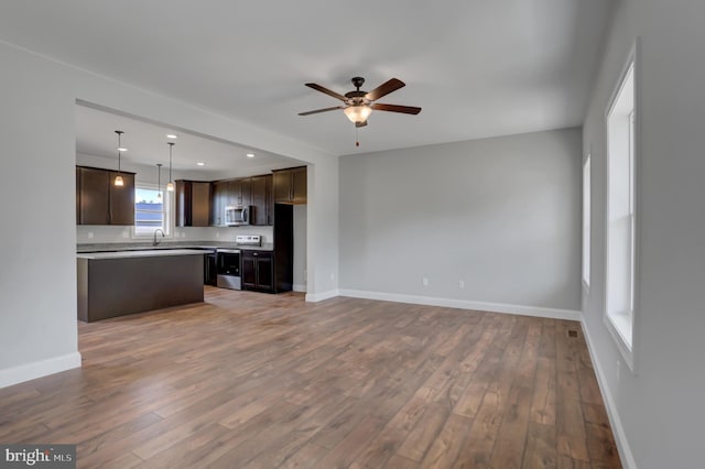 301 Rine Dr, Shippensburg, PA 17257 - unfurnished living room featuring a ceiling fan, wood finished floors, baseboards, a sink, and recessed lighting