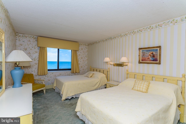 2901 Atlantic Ave Unit 404, Ocean City, MD 21842 - bedroom featuring wallpapered walls, carpet, a water view, and a textured ceiling
