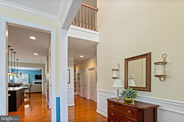 43 Triple Crown Dr Unit 441, Taneytown, MD 21787 - hall with wood finished floors, a wainscoted wall, a chandelier, and a decorative wall