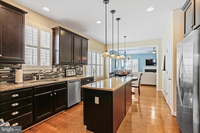43 Triple Crown Dr Unit 441, Taneytown, MD 21787 - kitchen featuring stainless steel appliances, a sink, decorative backsplash, light wood-style floors, and a center island