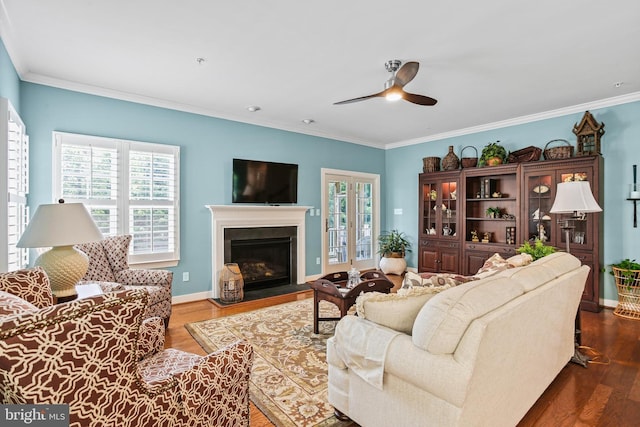 43 Triple Crown Dr Unit 441, Taneytown, MD 21787 - living area with a ceiling fan, dark wood finished floors, ornamental molding, a fireplace with raised hearth, and baseboards