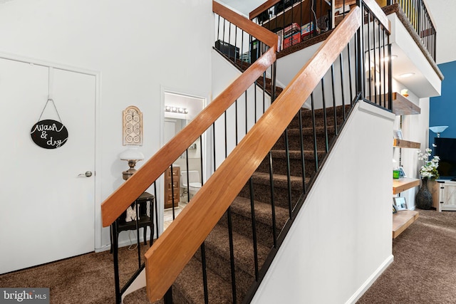 70302 Delaire Landing Rd Unit 302, Philadelphia, PA 19114 - staircase with carpet and a towering ceiling