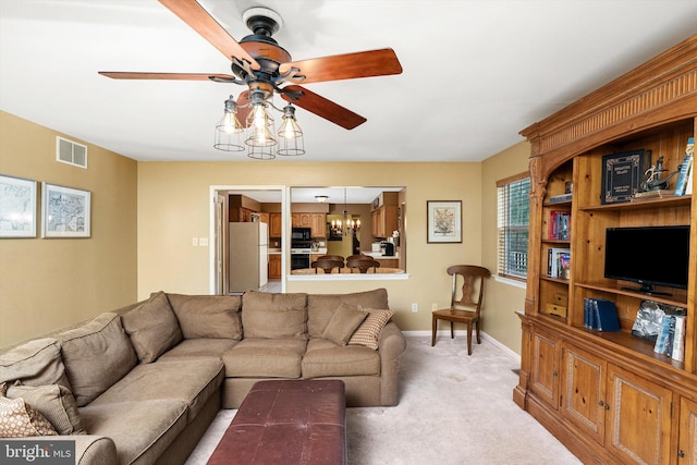 124 Kirschling Dr, Woolwich Twp, NJ 08085 - living room featuring a ceiling fan, a chandelier, light colored carpet, and baseboards