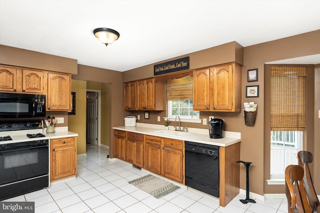124 Kirschling Dr, Woolwich Twp, NJ 08085 - kitchen with black appliances, a sink, light countertops, baseboards, and brown cabinets