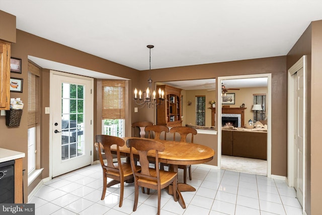 124 Kirschling Dr, Woolwich Twp, NJ 08085 - dining area featuring a premium fireplace, baseboards, a chandelier, and ceiling fan