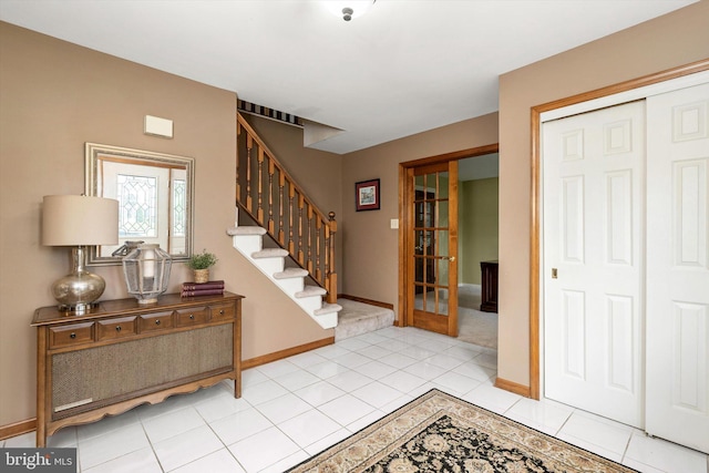 124 Kirschling Dr, Woolwich Twp, NJ 08085 - foyer entrance featuring stairway, baseboards, light tile patterned flooring, and light colored carpet