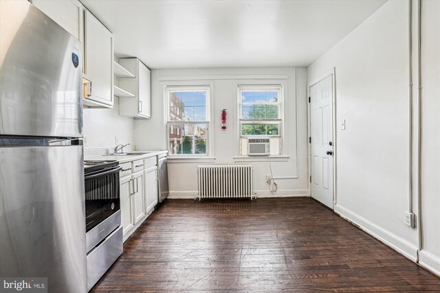 2425 E St NE, Washington, DC 20002 - kitchen featuring appliances with stainless steel finishes, radiator, dark wood finished floors, white cabinets, and open shelves