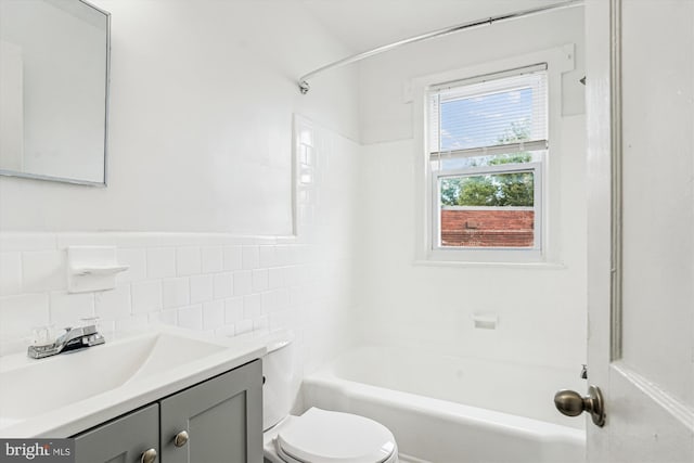 2425 E St NE, Washington, DC 20002 - bathroom with toilet, vanity,  shower combination, and tile walls