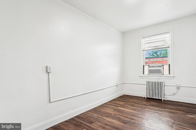 2425 E St NE, Washington, DC 20002 - spare room with radiator heating unit, dark wood-style floors, and baseboards