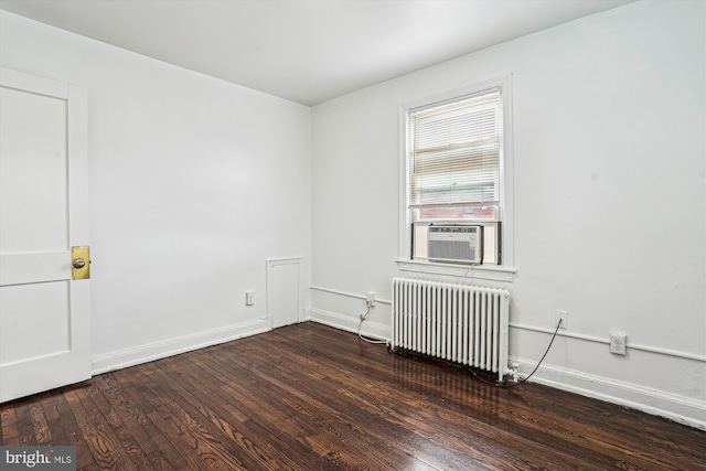 2425 E St NE, Washington, DC 20002 - spare room featuring radiator heating unit, cooling unit, wood finished floors, and baseboards