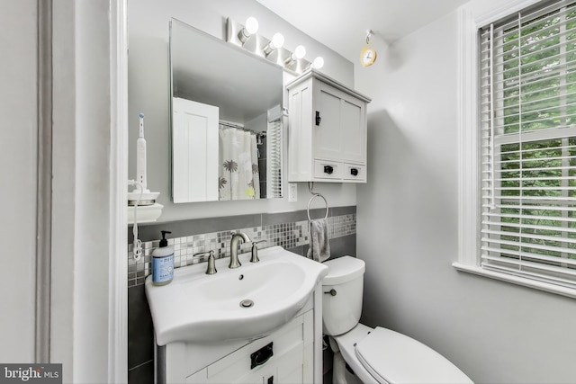 2725 Ordway St NW Unit 2, Washington, DC 20008 - bathroom featuring vanity, plenty of natural light, toilet, and backsplash