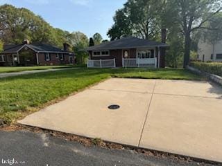 7686 Briar Ln, Pasadena, MD 21122 - view of front of home featuring a front yard and a porch