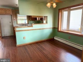 7686 Briar Ln, Pasadena, MD 21122 - kitchen with ceiling fan, a baseboard radiator, dark wood-type flooring, baseboards, and light countertops