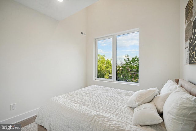 1307 Longfellow St NW Unit 10B, Washington, DC 20011 - bedroom with dark wood-style flooring, baseboards, and a towering ceiling