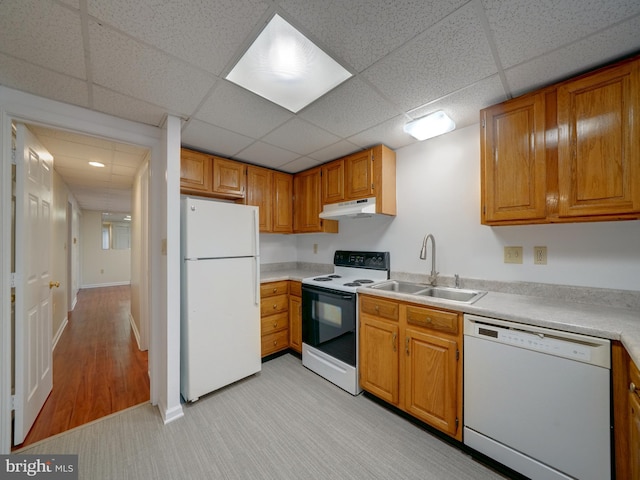 9407 7th St N, Laurel, MD 20723 - kitchen with white appliances, under cabinet range hood, a sink, light countertops, and a drop ceiling