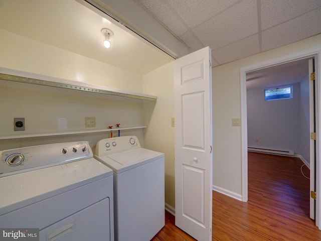 9407 7th St N, Laurel, MD 20723 - washroom featuring baseboard heating, washing machine and clothes dryer, wood finished floors, and baseboards