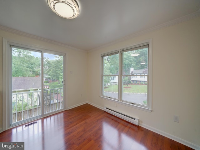 9407 7th St N, Laurel, MD 20723 - empty room featuring baseboard heating, plenty of natural light, wood finished floors, baseboards, and ornamental molding