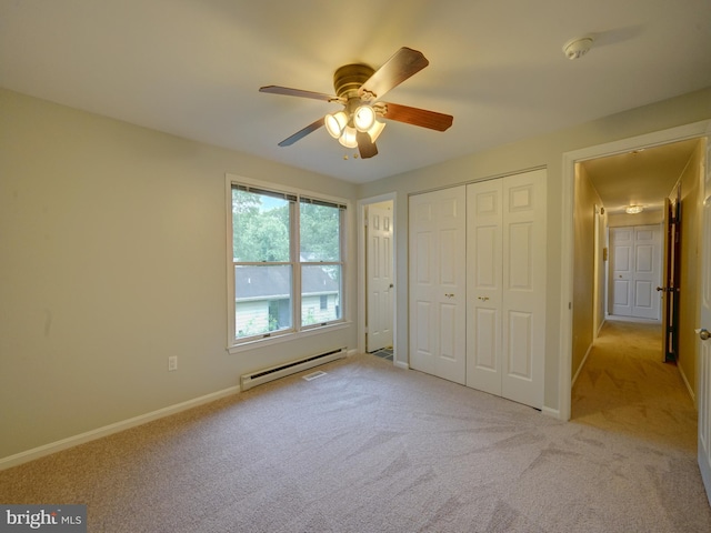 9407 7th St N, Laurel, MD 20723 - unfurnished bedroom with baseboard heating, carpet flooring, a closet, baseboards, and ceiling fan