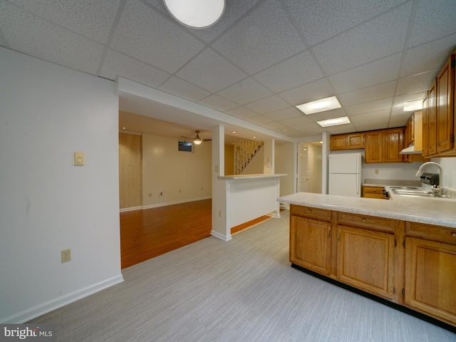 9407 7th St N, Laurel, MD 20723 - kitchen featuring freestanding refrigerator, light countertops, a sink, light carpet, and brown cabinets